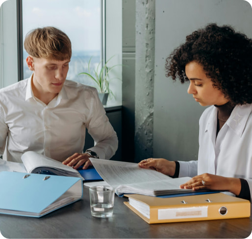 Business professionals at Management Key Consulting strategizing over documents